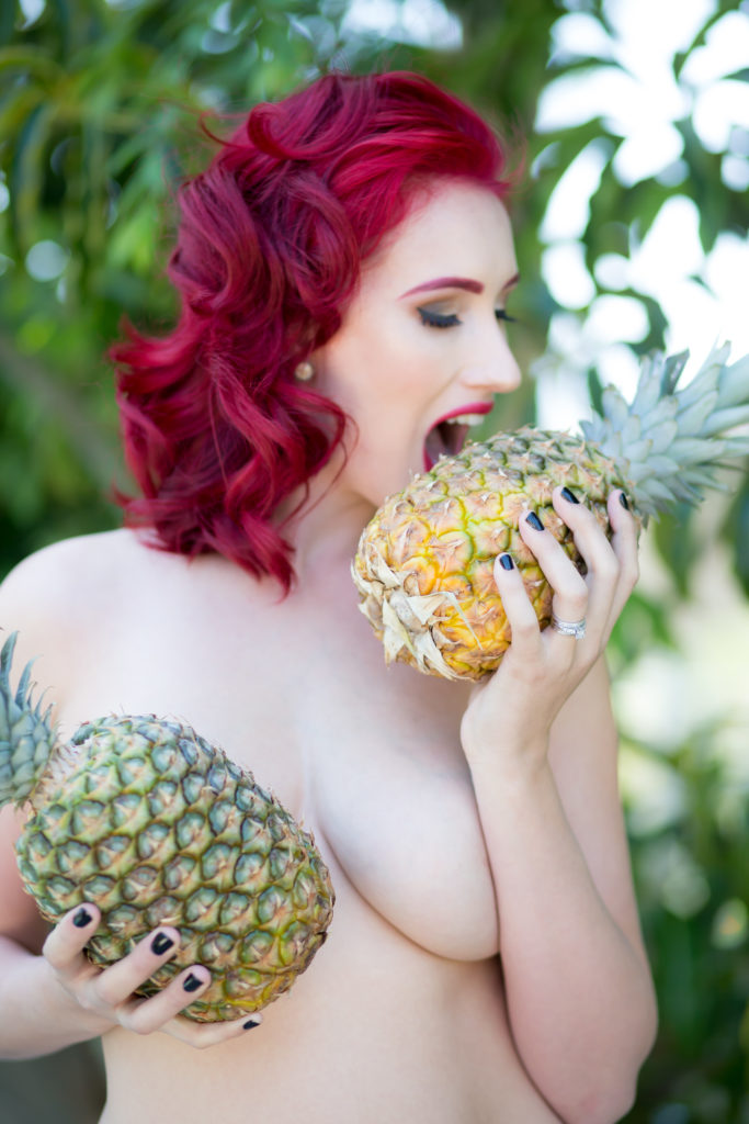 implied nude eating pineapple 