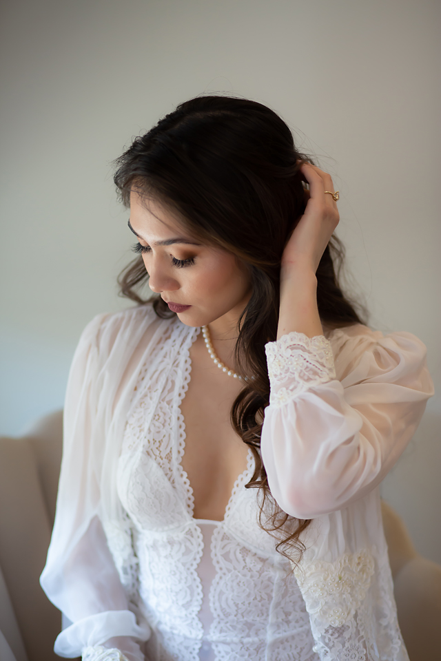 Temecula bride in white lingerie and white robe with a pearl necklace in Old Town Temecula. Photos by Kellie Foster Photography and Spark Boudoir. 